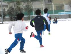 運動場で雪遊びをする三樹っ子たち