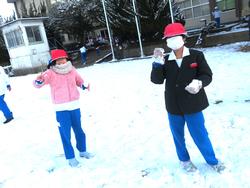 運動場で雪遊びをする三樹っ子たち