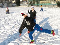 運動場で雪遊びをする三樹っ子たち