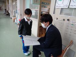 担任より通知表を手渡し